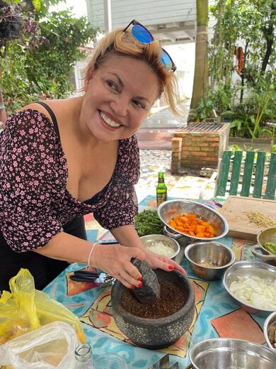 Guest grinding fresh masala in the Singing Chef secret garden