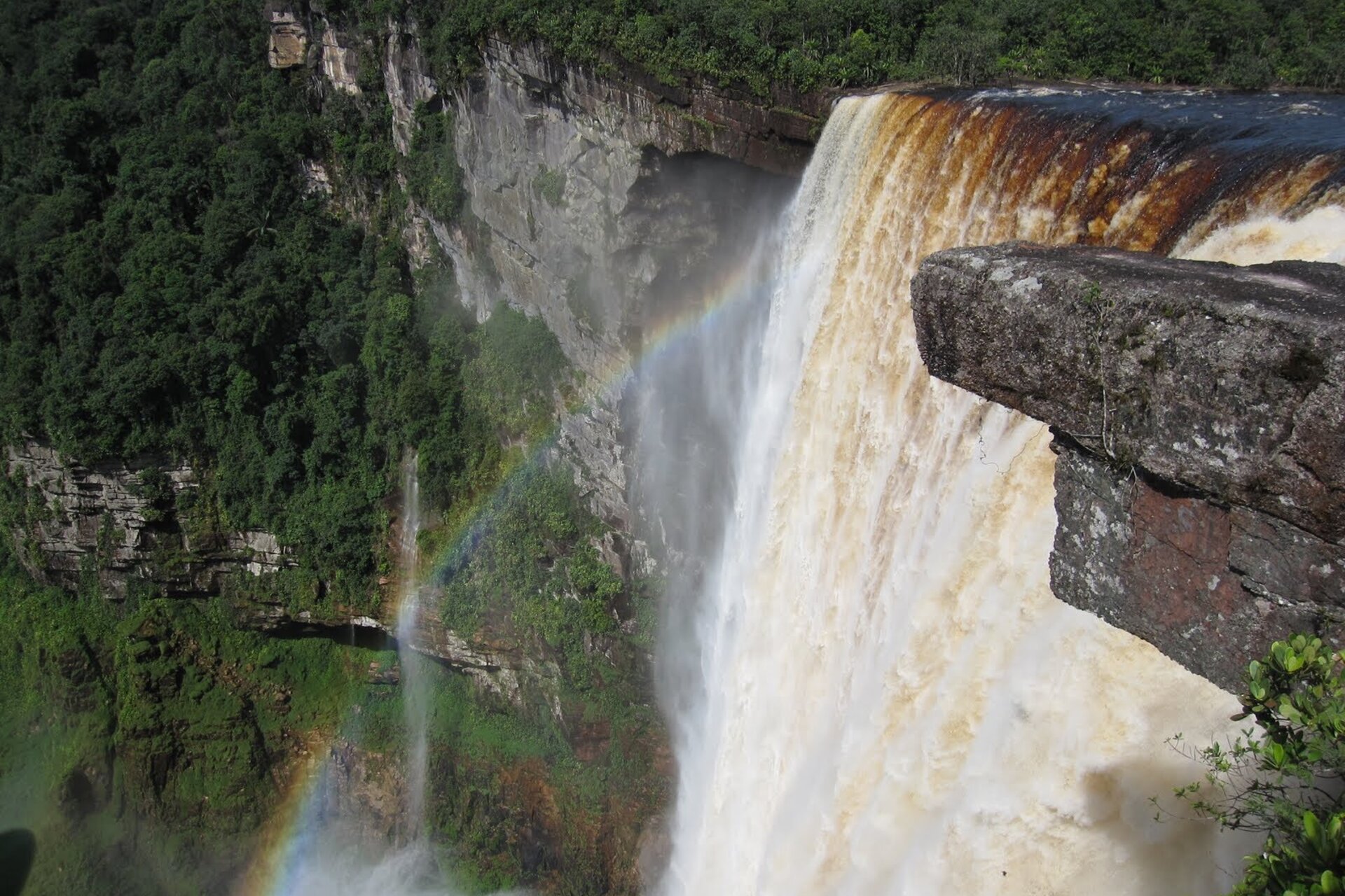 Close-up of Kaieteur Falls with rainbow forming in the mist